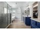 Spa-like bathroom with soaking tub, walk-in shower, and blue vanity at 42280 Kingsmill Cir, Elizabeth, CO 80107
