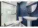 Modern bathroom with navy blue walls and pedestal sink at 42280 Kingsmill Cir, Elizabeth, CO 80107