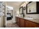 Double vanity bathroom with dark wood cabinets at 42280 Kingsmill Cir, Elizabeth, CO 80107