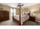 Charming bedroom with post bed, dresser, and window seating at 42280 Kingsmill Cir, Elizabeth, CO 80107