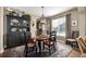 Dining room with dark wood hutch and round table with four chairs at 42280 Kingsmill Cir, Elizabeth, CO 80107