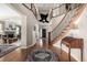 Grand entryway with hardwood floors, curved staircase, and views into the living room at 42280 Kingsmill Cir, Elizabeth, CO 80107