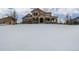 Beautiful home in winter with a welcoming front porch and a snow-covered yard at 42280 Kingsmill Cir, Elizabeth, CO 80107