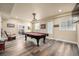 Finished basement game room with pool table, comfortable seating, and hardwood floors at 42280 Kingsmill Cir, Elizabeth, CO 80107