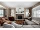 Living room with stone fireplace, sectional sofa, and large windows at 42280 Kingsmill Cir, Elizabeth, CO 80107