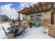 Cozy patio with pergola, fire pit, and seating area at 42280 Kingsmill Cir, Elizabeth, CO 80107