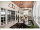 Bright sunroom with glass doors and a dining table set at 42280 Kingsmill Cir, Elizabeth, CO 80107