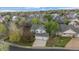 Aerial view of a well-maintained home with a three car garage, surrounded by lush greenery at 248 Summit Trl, Broomfield, CO 80020