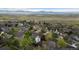 Neighborhood aerial view showcasing manicured lawns and open green spaces and mountain views at 248 Summit Trl, Broomfield, CO 80020