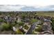 Wide aerial shot showcasing the neighborhood's layout, green spaces, and the scenic mountain view beyond at 248 Summit Trl, Broomfield, CO 80020