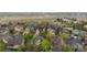Aerial view of a neighborhood street surrounded by mature trees, residences and lush landscaping at 248 Summit Trl, Broomfield, CO 80020