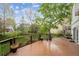 Inviting back deck with dark railings, lush landscaping, and neighborhood views at 248 Summit Trl, Broomfield, CO 80020