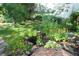 A serene backyard pond adds natural beauty to this home with lush landscaping and flower accents at 248 Summit Trl, Broomfield, CO 80020