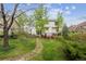 Exterior view of a home with a lush green backyard and a charming stone walkway at 248 Summit Trl, Broomfield, CO 80020