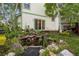 Backyard with a peaceful pond surrounded by lush greenery near sliding glass doors at 248 Summit Trl, Broomfield, CO 80020