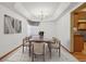 Bright dining room features a modern chandelier, a tray ceiling, and neutral décor at 248 Summit Trl, Broomfield, CO 80020