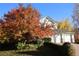 Charming two-story home with a three car garage, neutral colored exterior, and autumn foliage at 248 Summit Trl, Broomfield, CO 80020