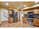 Spacious kitchen featuring stainless steel appliances, wooden cabinets and hardwood floors at 248 Summit Trl, Broomfield, CO 80020