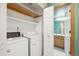 Convenient laundry area with modern washer and dryer, next to the bathroom at 248 Summit Trl, Broomfield, CO 80020