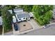 Aerial view of a charming house with a well-maintained yard, driveway, and mature trees at 3111 W Bails Pl, Denver, CO 80219