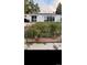 View of backyard with flower garden bed full of colorful flowers at 3111 W Bails Pl, Denver, CO 80219