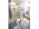 Modern bathroom featuring glass shower with tile accent wall, contemporary vanity and matching ceramic tile floor at 3111 W Bails Pl, Denver, CO 80219