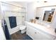 Bright bathroom featuring wood floors, a shower and tub combo, and updated vanity with sink at 3111 W Bails Pl, Denver, CO 80219