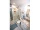 Updated bathroom featuring a glass-enclosed shower with marble tile and modern fixtures at 3111 W Bails Pl, Denver, CO 80219