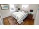 Cozy bedroom with hardwood floors, natural light, and a comfortable bed at 3111 W Bails Pl, Denver, CO 80219