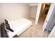 Bedroom featuring neutral carpet, a doorway, and a closet for ample storage at 3111 W Bails Pl, Denver, CO 80219