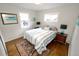 Cozy bedroom with hardwood floors, natural light, and neutral decor at 3111 W Bails Pl, Denver, CO 80219