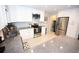 Well-lit kitchen featuring granite countertops, stainless steel appliances, and white cabinets at 3111 W Bails Pl, Denver, CO 80219