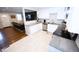 Bright, modern kitchen with open layout to the living area, stainless appliances, and white cabinetry at 3111 W Bails Pl, Denver, CO 80219