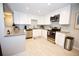 Bright kitchen featuring stainless steel appliances, ample counter space, and white cabinetry at 3111 W Bails Pl, Denver, CO 80219