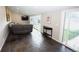 Cozy living room with large window, dark tile flooring, and a comfortable couch at 3111 W Bails Pl, Denver, CO 80219