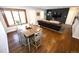 Open-concept living room featuring hardwood floors, ample natural light, and comfortable seating at 3111 W Bails Pl, Denver, CO 80219