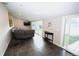 Open living room with sliding glass doors provide ample natural light and outdoor access to the fenced yard at 3111 W Bails Pl, Denver, CO 80219