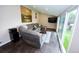 Cozy living room featuring a comfortable sofa and large sliding glass doors to bring the outdoors in at 3111 W Bails Pl, Denver, CO 80219