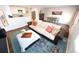 Open concept living space with hardwood floors, cozy sofa, and modern decor at 3111 W Bails Pl, Denver, CO 80219