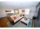 Cozy living area with hardwood floors, stylish rug, and comfortable sofa at 3111 W Bails Pl, Denver, CO 80219