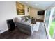 Comfortable sun room with a large sectional sofa, tiled floor, and sliding glass doors at 3111 W Bails Pl, Denver, CO 80219