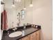 Bathroom vanity with a large mirror, granite countertops, and updated lighting at 6379 S Jasmine Way, Centennial, CO 80111