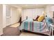 A cozy bedroom features a decorative quilt and a stuffed bear on the bed at 6379 S Jasmine Way, Centennial, CO 80111