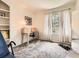 Bright and airy bedroom with neutral walls, a light wood desk, and ample natural light at 6379 S Jasmine Way, Centennial, CO 80111