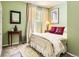 Comfortable bedroom showcasing warm green walls, soft lighting, and inviting decor at 6379 S Jasmine Way, Centennial, CO 80111