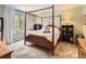 Cozy bedroom featuring a four-poster bed, natural light, and neutral tones to create a relaxing atmosphere at 6379 S Jasmine Way, Centennial, CO 80111