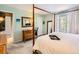 Calming bedroom with a four-poster bed, dresser, and a large window at 6379 S Jasmine Way, Centennial, CO 80111