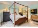 Comfortable bedroom featuring a four-poster bed, a dresser, and modern decor at 6379 S Jasmine Way, Centennial, CO 80111