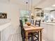 Charming dining area with a farmhouse table, natural light and updated pendant lights at 6379 S Jasmine Way, Centennial, CO 80111