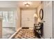 Welcoming entryway featuring double doors, tile flooring, bench and soft natural light at 6379 S Jasmine Way, Centennial, CO 80111